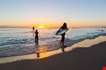 Surfboard Rider In The Sunset Of Waikiki Beach On Oahu Hawaii-Surfboard Rider In The Sunset Of Waikiki Beach On Oahu Hawaii